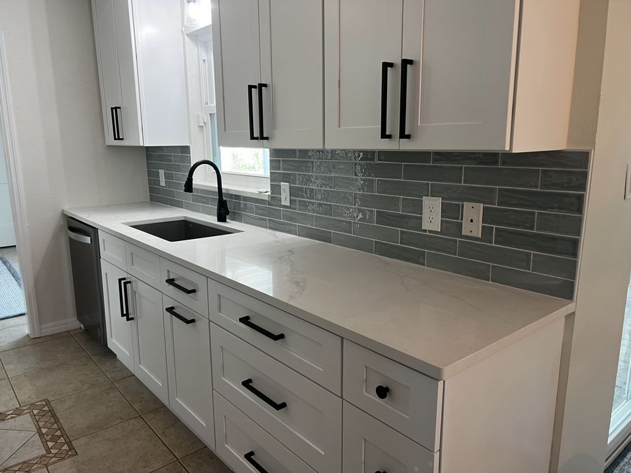 Custom laundry room cabinetry and tile backsplash